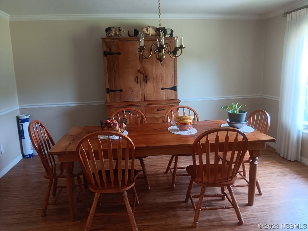 4141 Sterling Street Mims, FL 32754 - Photo 5 of 20 a view of a dining room with furniture and wooden floor