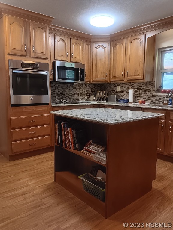 4141 Sterling Street Mims, FL 32754 - Photo 6 of 20 a kitchen with stainless steel appliances granite countertop a stove and a microwave
