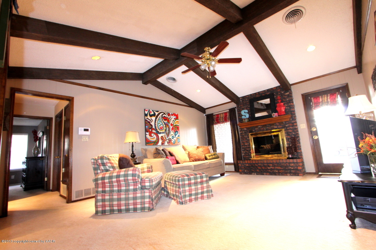 5304 South Fannin Street Amarillo, TX 79110 - Photo 1 of 23 a living room with furniture a flat screen tv and a fireplace