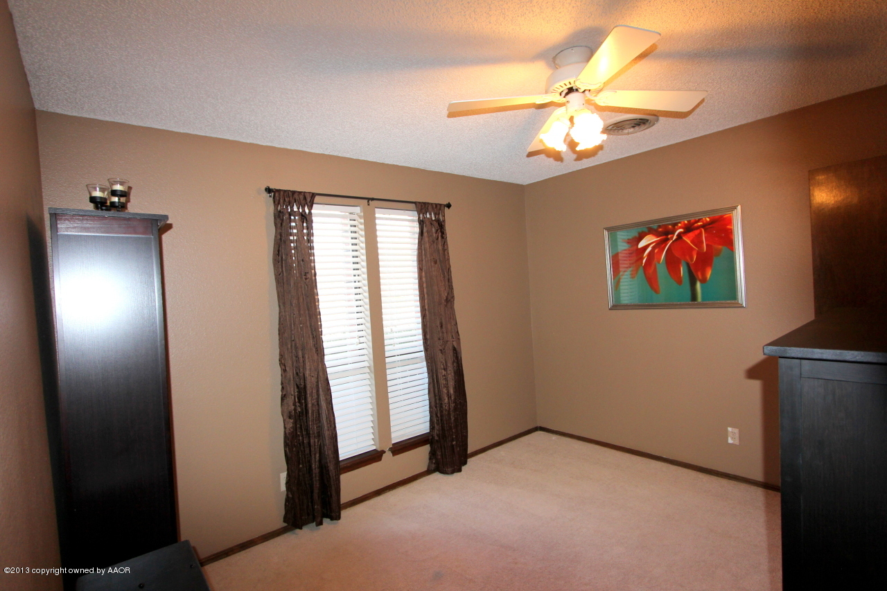 5304 South Fannin Street Amarillo, TX 79110 - Photo 14 of 23 wooden floor in an empty room with a window
