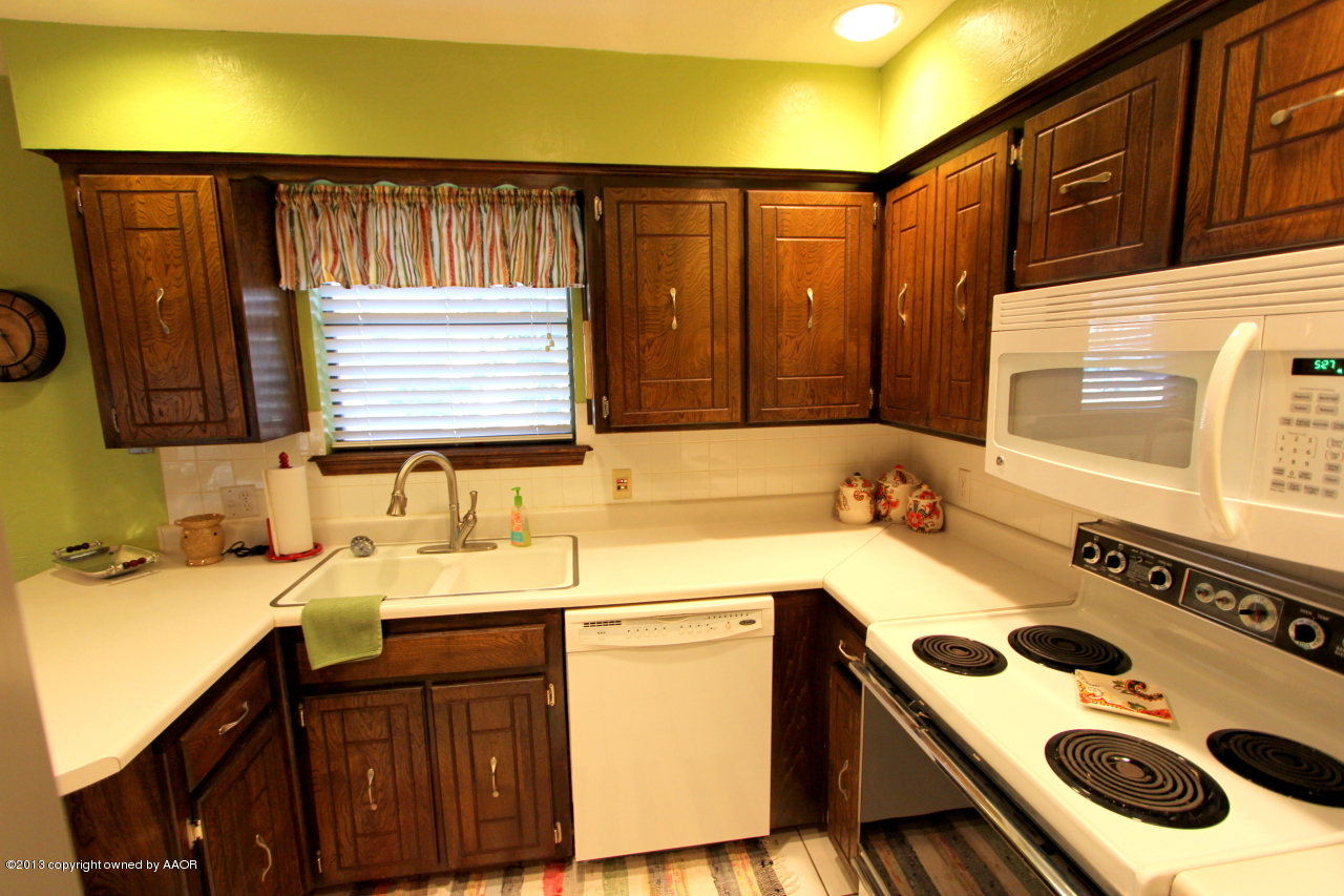 5304 South Fannin Street Amarillo, TX 79110 - Photo 15 of 23 a kitchen with a sink stove and cabinets