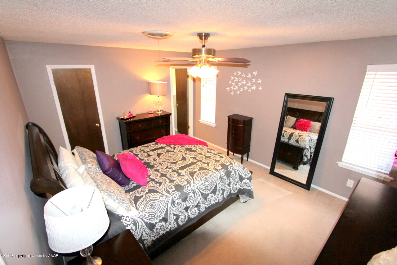 5304 South Fannin Street Amarillo, TX 79110 - Photo 7 of 23 a bed room with a bed window and a flat screen tv
