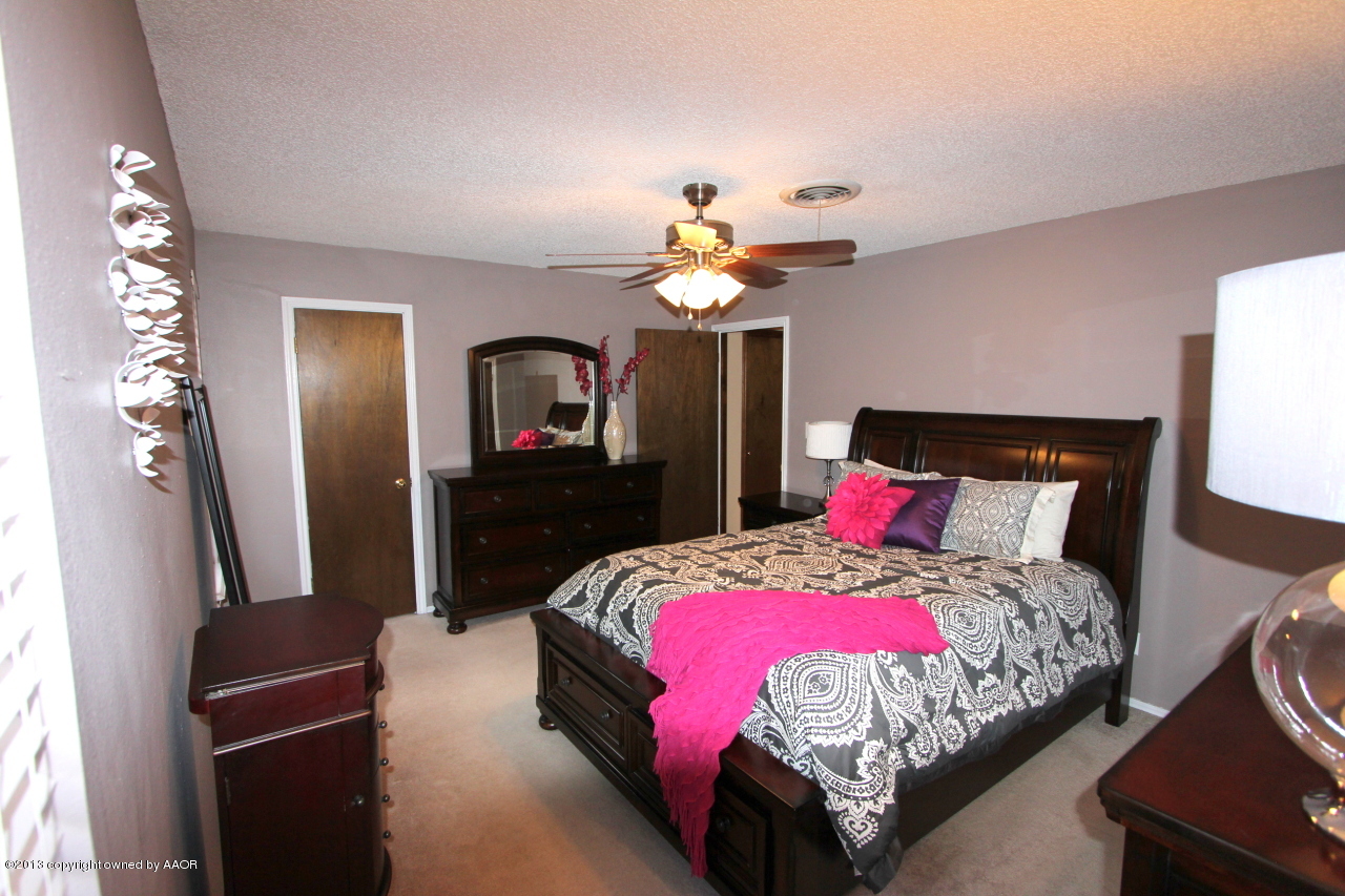 5304 South Fannin Street Amarillo, TX 79110 - Photo 8 of 23 a bedroom with a bed and a mirror