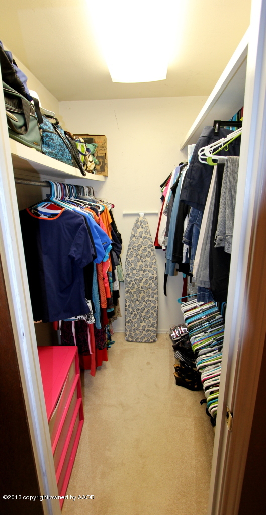 5304 South Fannin Street Amarillo, TX 79110 - Photo 9 of 23 a view of walk in closet with clothes and shoes