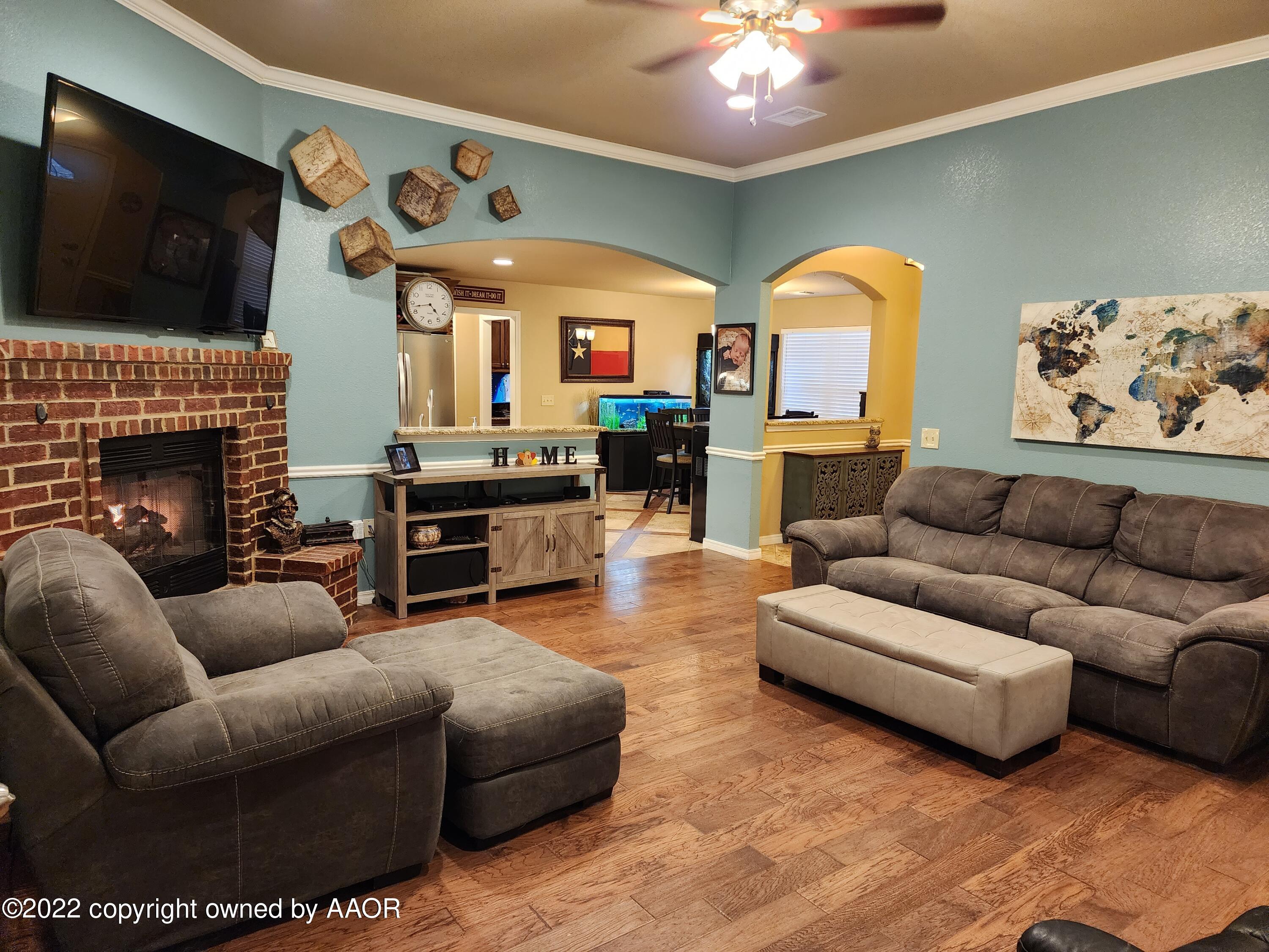 3912 Arden Road Amarillo, TX 79118 - Photo 35 of 35 a living room with furniture a flat screen tv and a fireplace