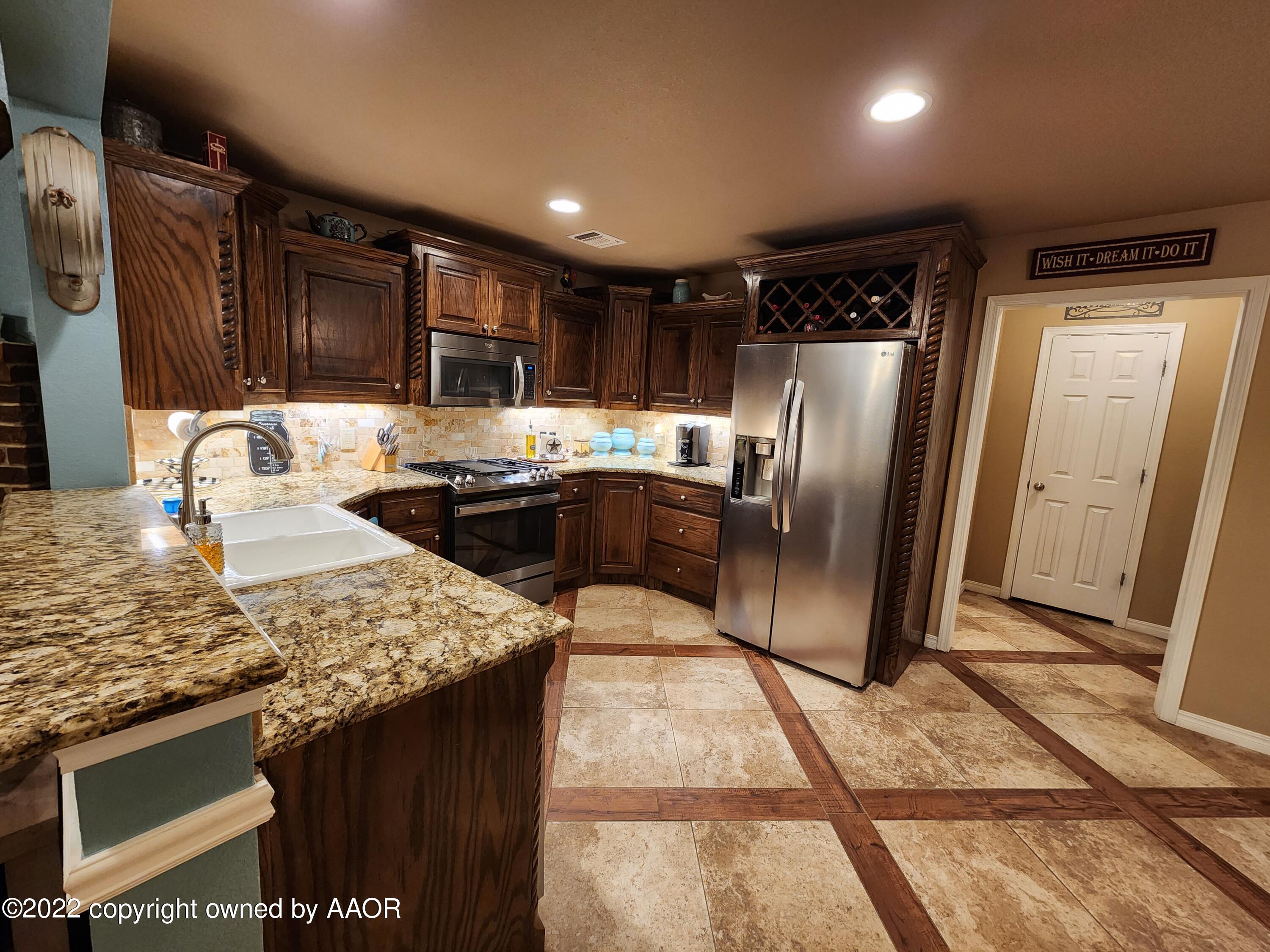 3912 Arden Road Amarillo, TX 79118 - Photo 12 of 35 a kitchen with stainless steel appliances granite countertop a refrigerator a sink a stove and island