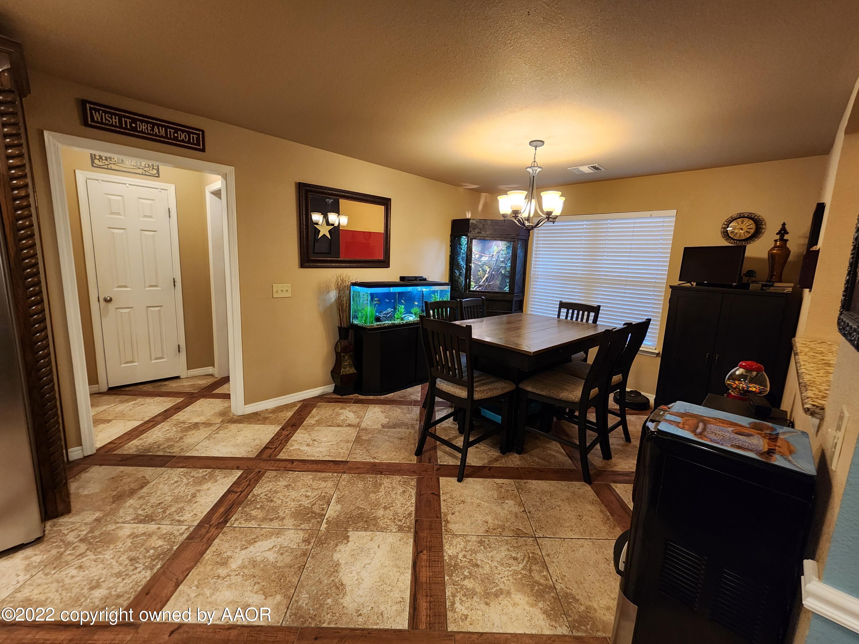 3912 Arden Road Amarillo, TX 79118 - Photo 14 of 35 a workspace with furniture and chandelier