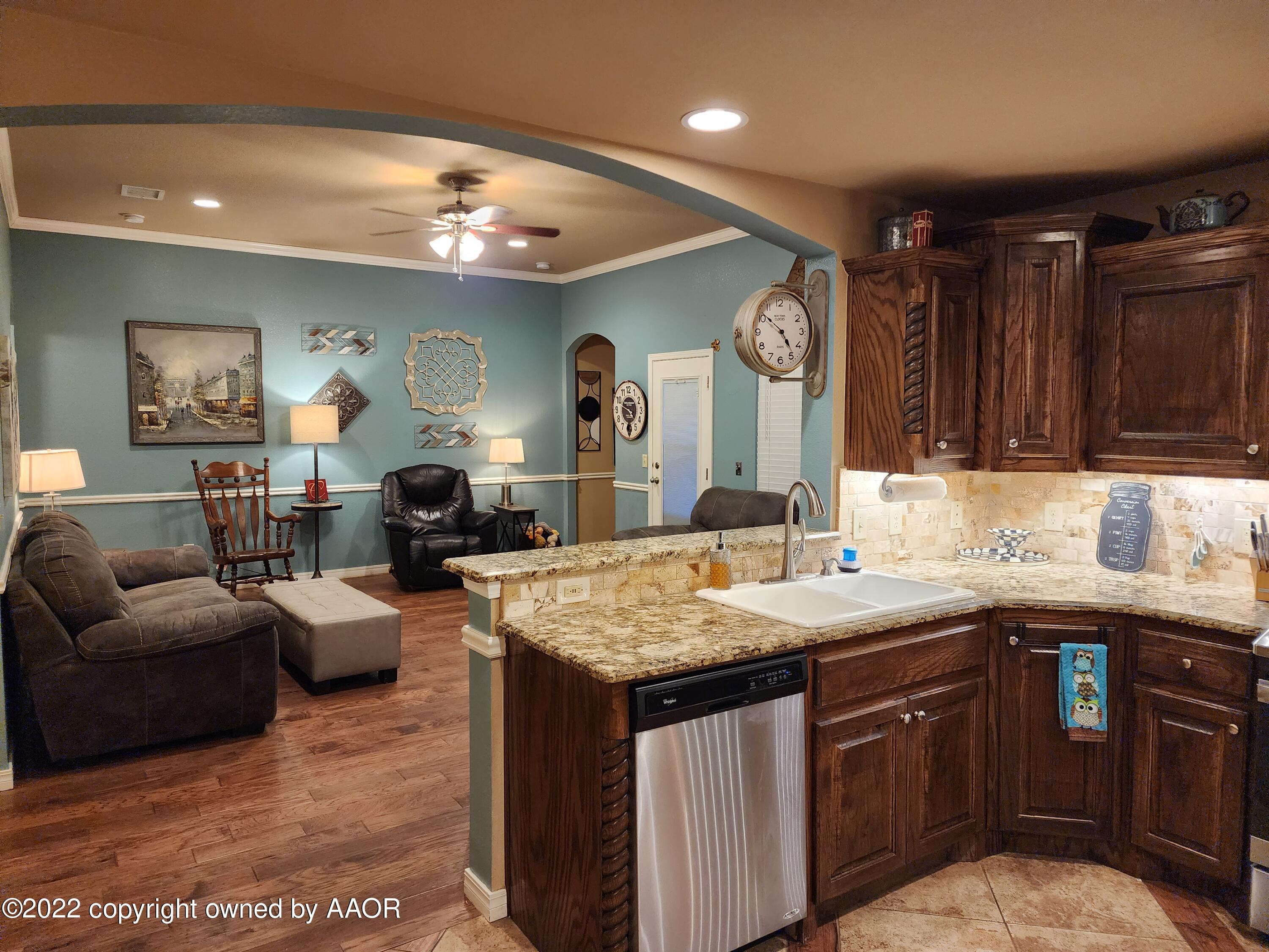 3912 Arden Road Amarillo, TX 79118 - Photo 16 of 35 a kitchen with a sink a counter space and living room