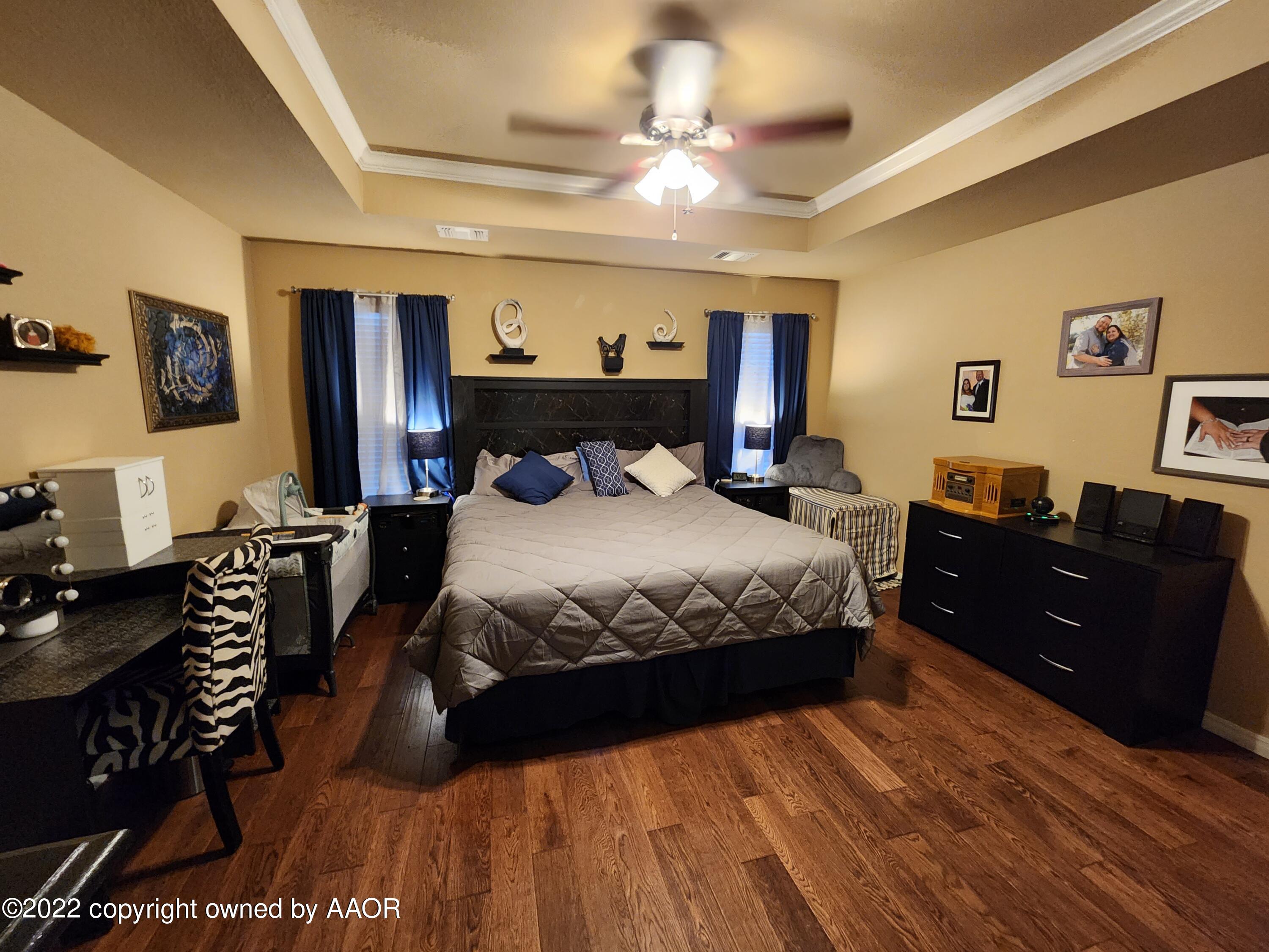 3912 Arden Road Amarillo, TX 79118 - Photo 18 of 35 a bedroom with a bed and dresser with mirror