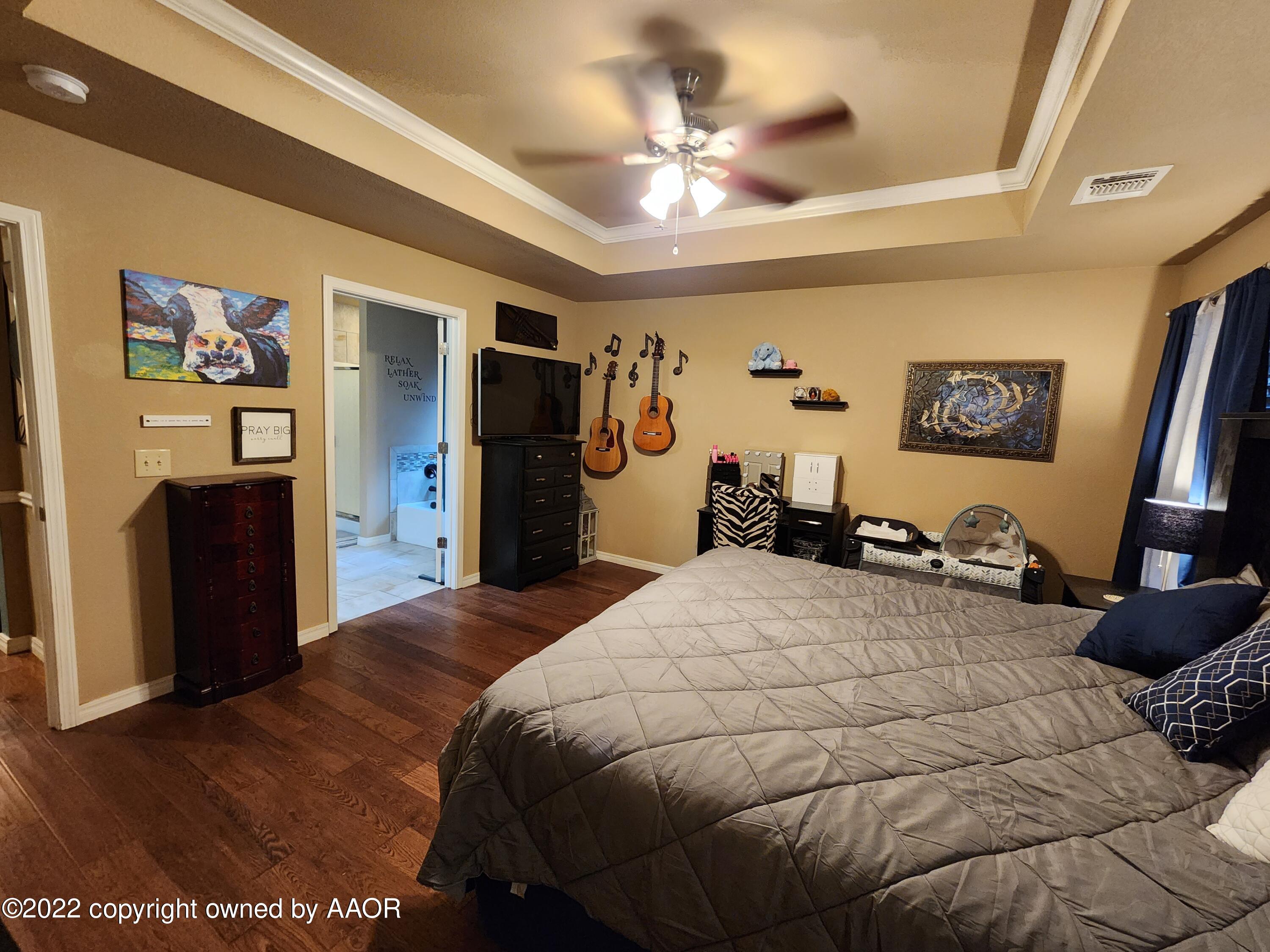 3912 Arden Road Amarillo, TX 79118 - Photo 19 of 35 a bedroom with a bed and a television