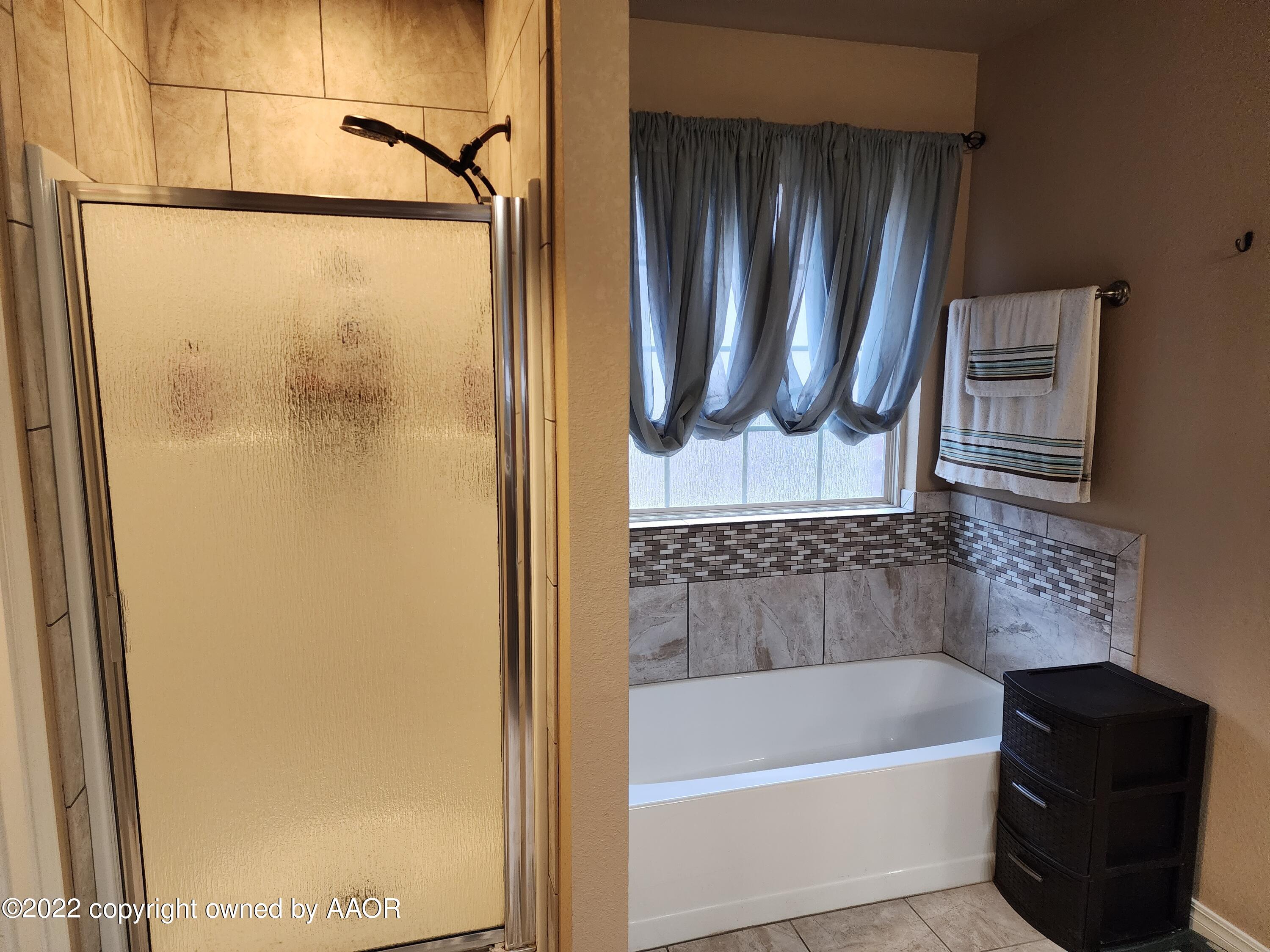 3912 Arden Road Amarillo, TX 79118 - Photo 21 of 35 a bathroom with a bathtub and a shower