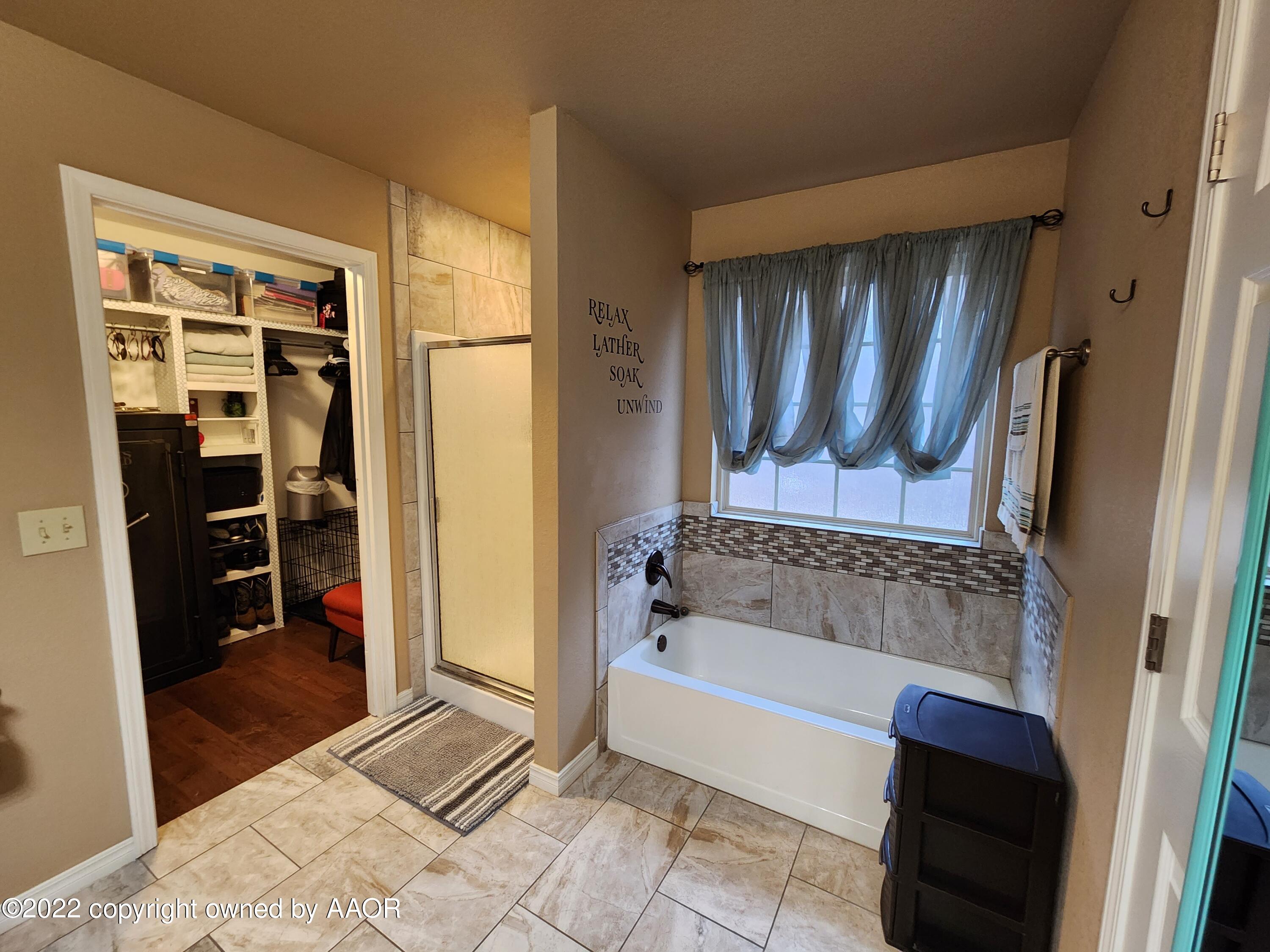 3912 Arden Road Amarillo, TX 79118 - Photo 22 of 35 a bathroom with a tub and a shower