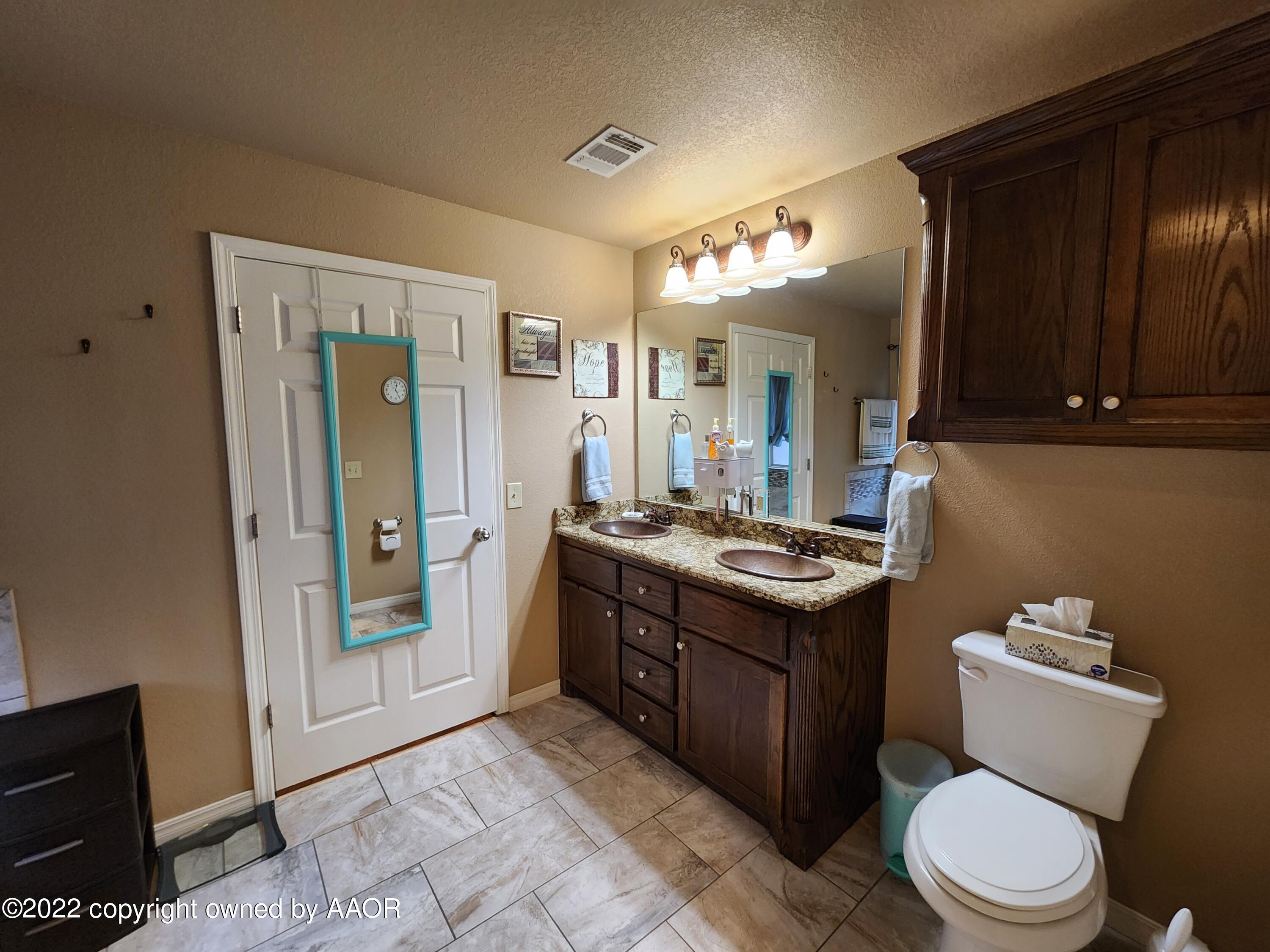 3912 Arden Road Amarillo, TX 79118 - Photo 23 of 35 a bathroom with a sink vanity toilet and shower