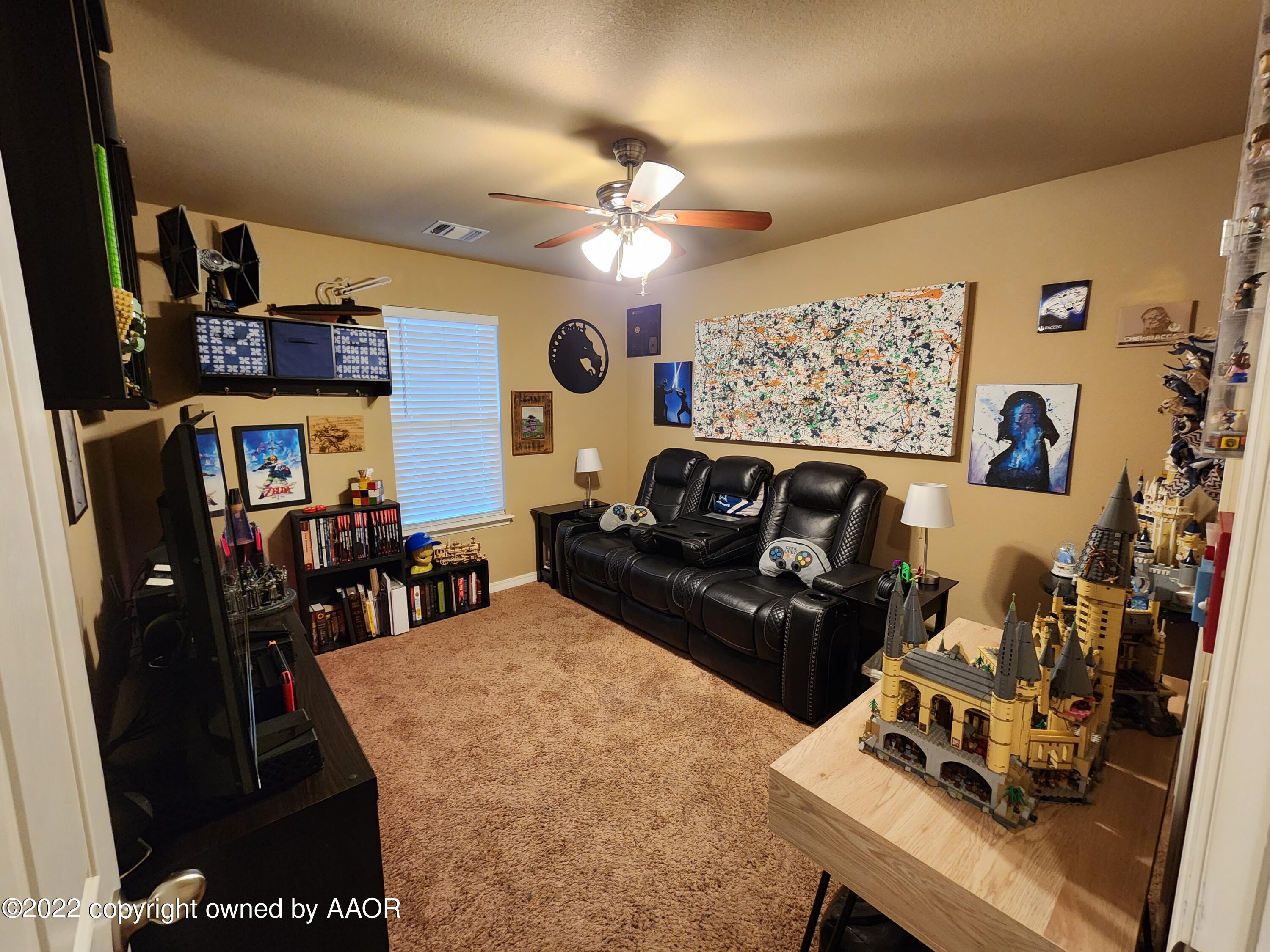 3912 Arden Road Amarillo, TX 79118 - Photo 26 of 35 a living room with furniture and a flat screen tv