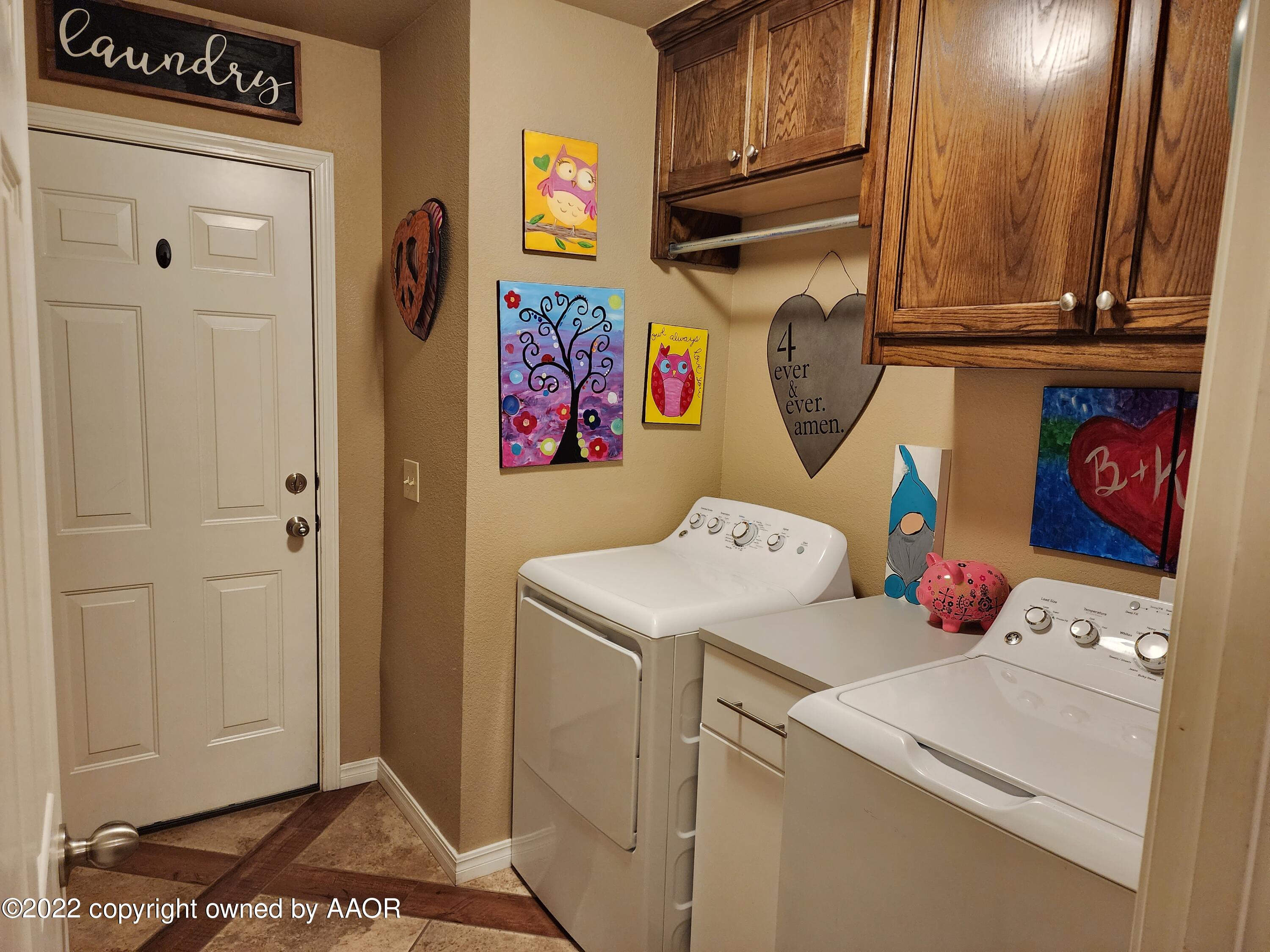 3912 Arden Road Amarillo, TX 79118 - Photo 30 of 35 a view of storage and utility room with washer and dryer