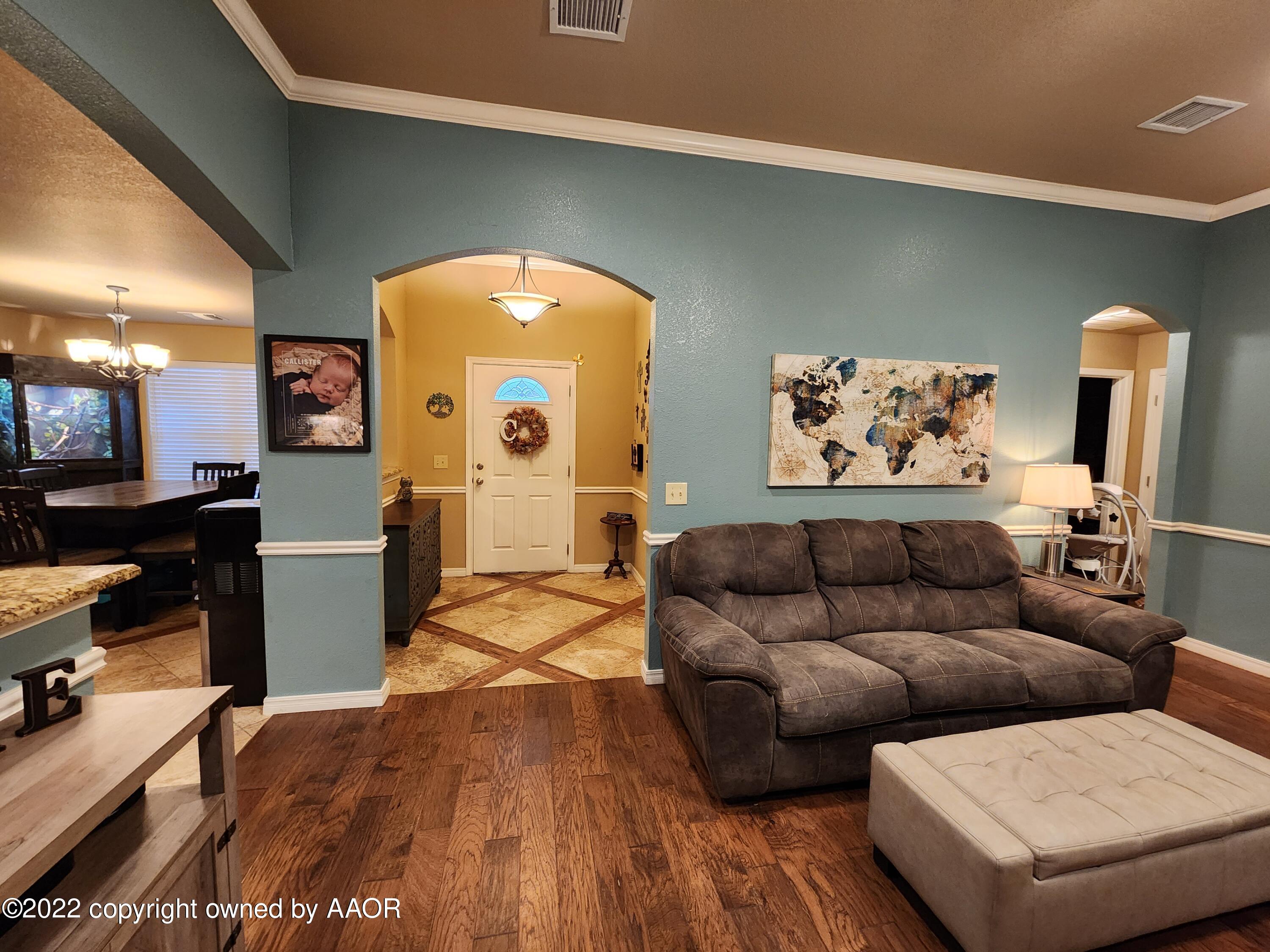 3912 Arden Road Amarillo, TX 79118 - Photo 7 of 35 a living room with furniture and a flat screen tv
