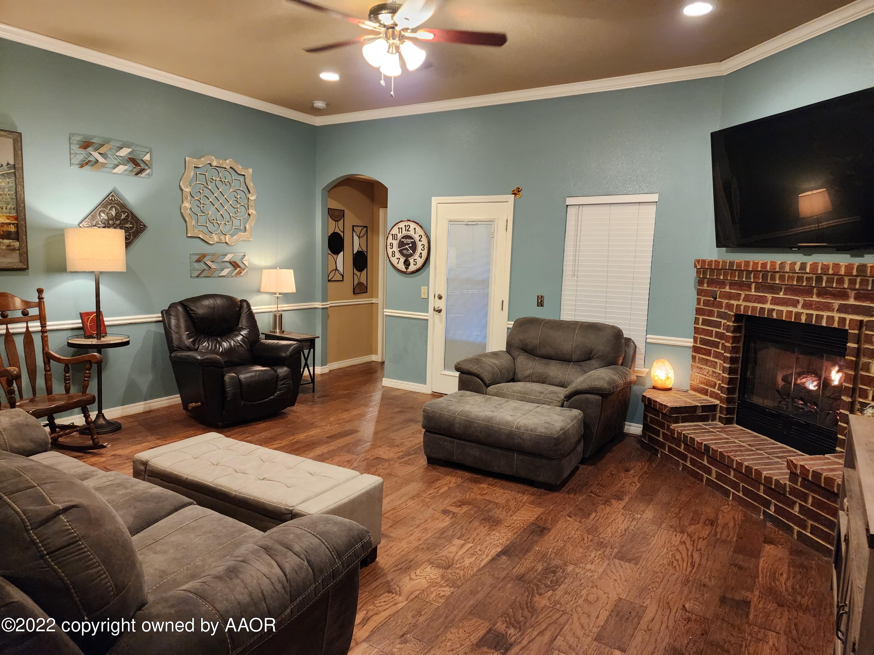 3912 Arden Road Amarillo, TX 79118 - Photo 8 of 35 a living room with furniture and a flat screen tv