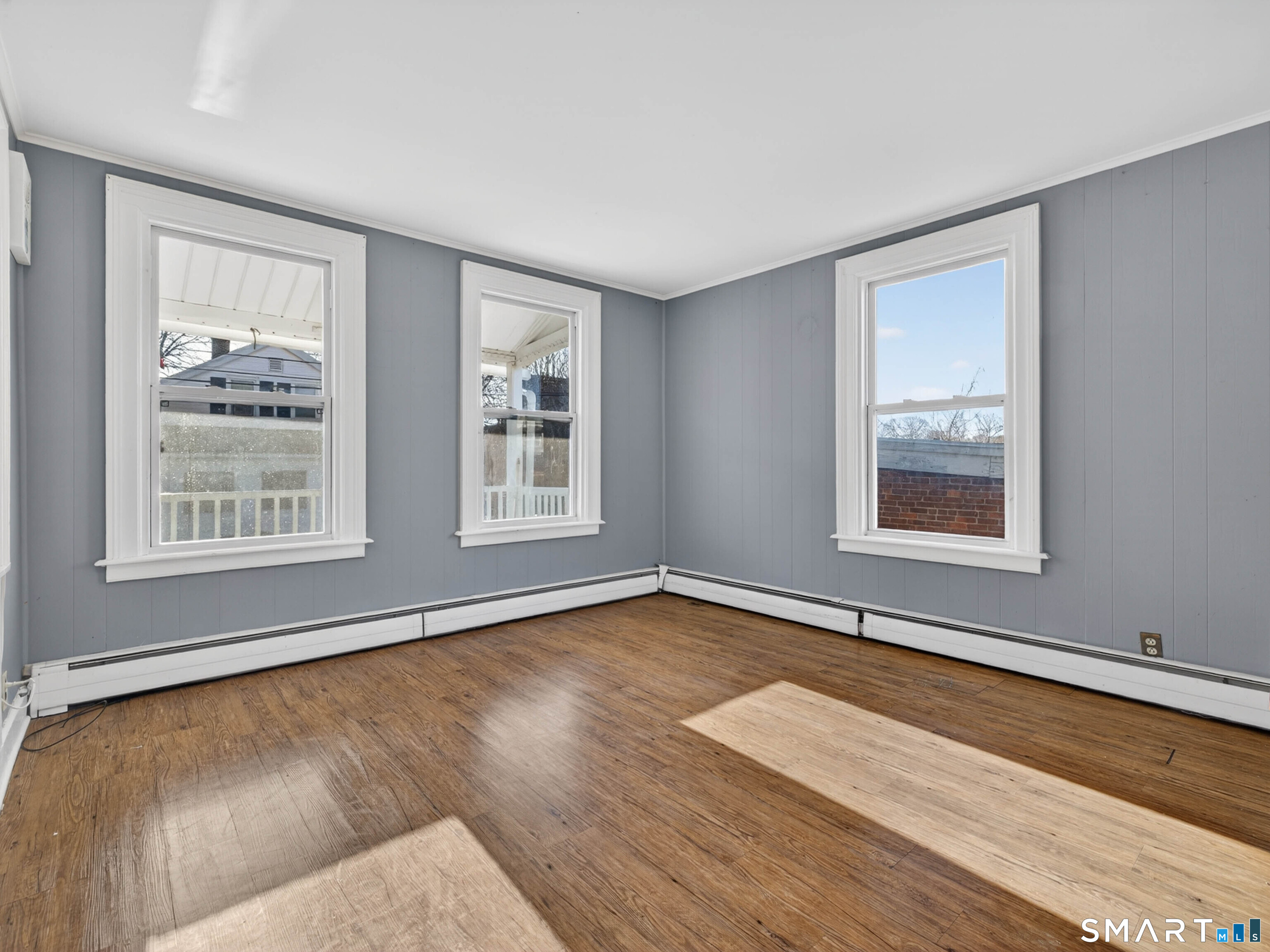 12 Clover Court New London, CT 06320 - Photo 12 of 29 a view of an empty room with window and wooden floor