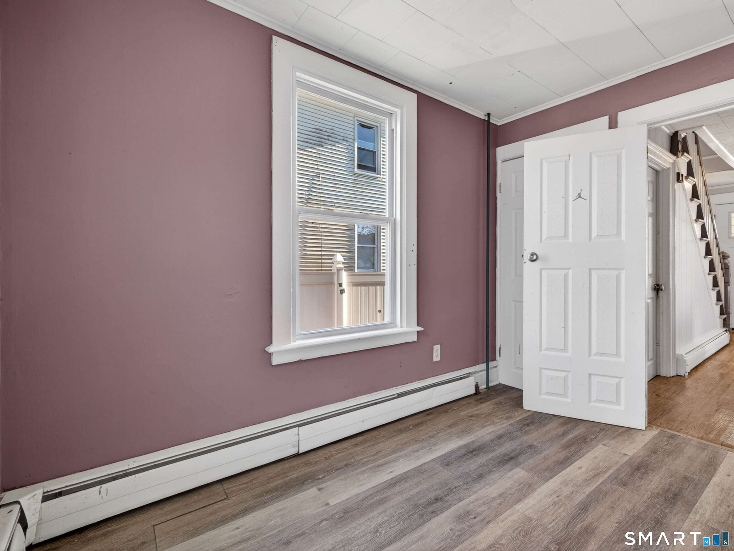 12 Clover Court New London, CT 06320 - Photo 14 of 29 a view of an empty room with wooden floor and a window