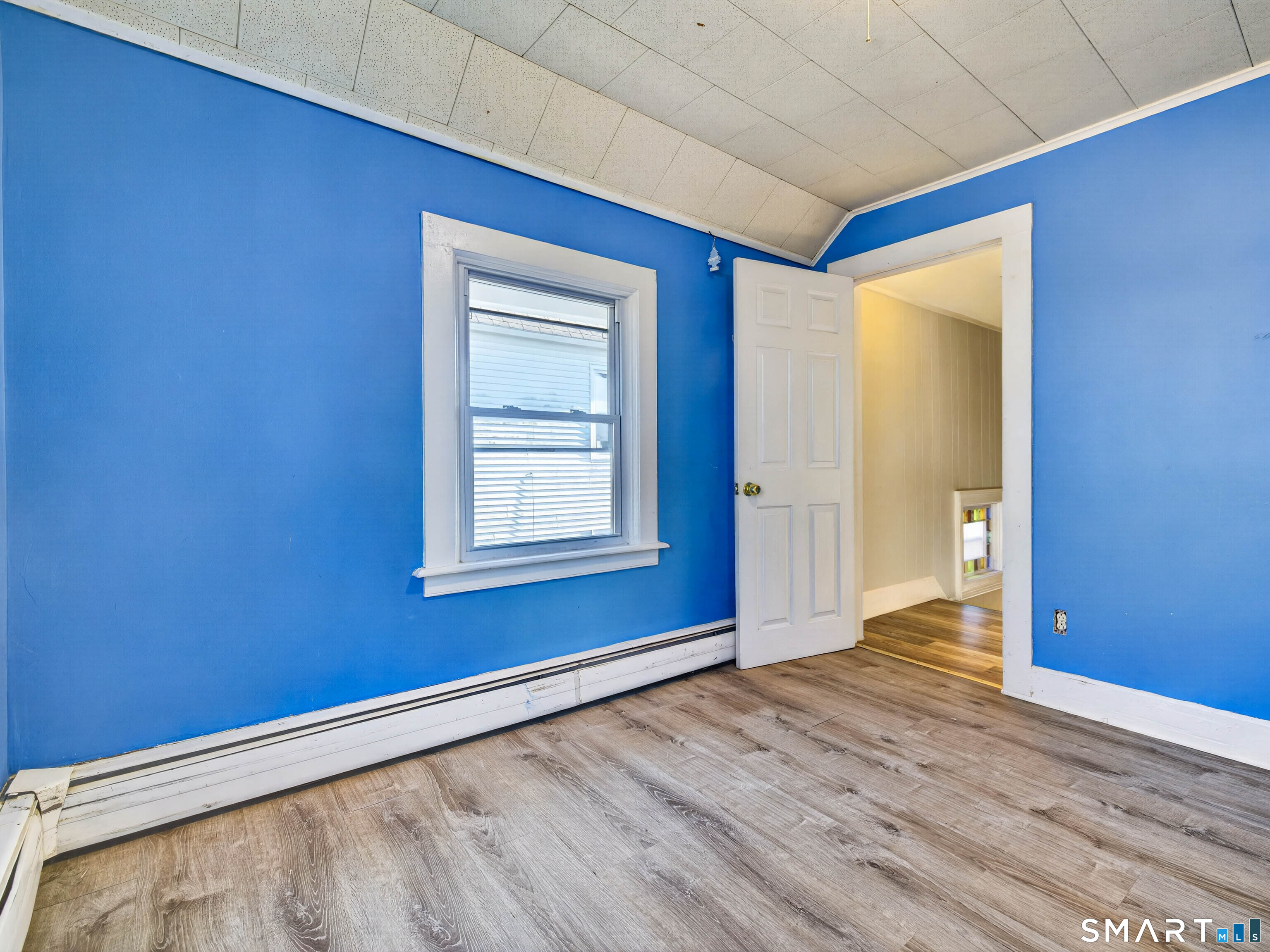 12 Clover Court New London, CT 06320 - Photo 21 of 29 a view of an empty room with wooden floor and a window