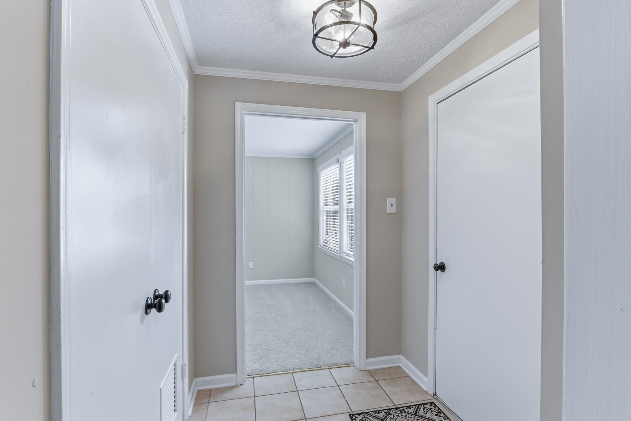 312 Fernway Road Memphis, TN 38117 - Photo 5 of 38 Hall with crown molding, light tile patterned floors, and light carpet