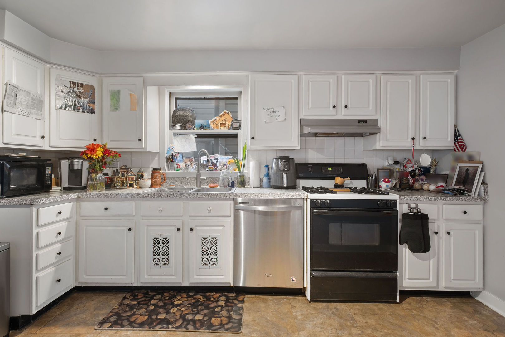 1934 West Race Avenue Chicago, IL 60622 - Photo 15 of 35 a kitchen with granite countertop white cabinets and white appliances