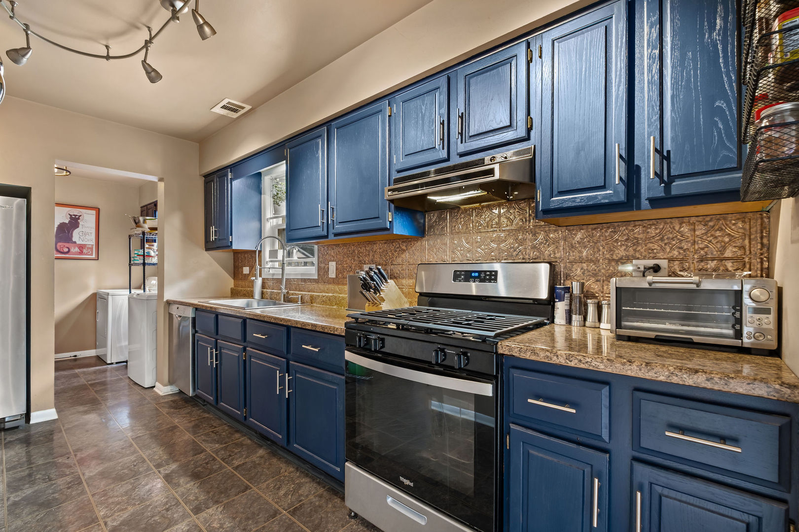 1934 West Race Avenue Chicago, IL 60622 - Photo 7 of 35 a kitchen with stainless steel appliances granite countertop wooden cabinets stove top oven and granite counter top