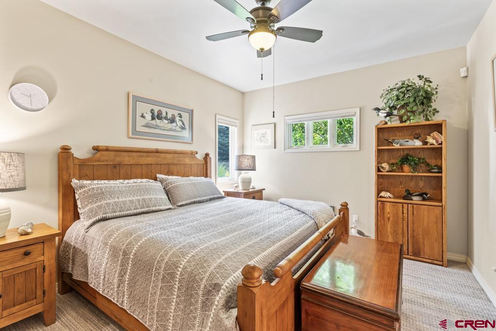 15103 6260th Road Montrose, CO 81403 - Photo 29 of 45 a bedroom with a bed and a chandelier