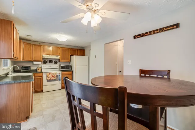 a kitchen with refrigerator cabinets and large window