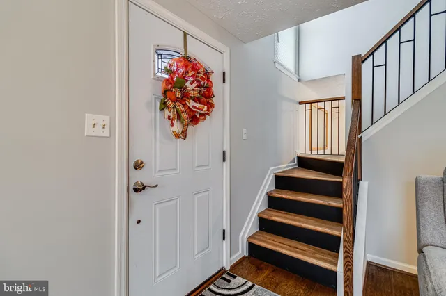 a view of entryway with stairs and wooden floor