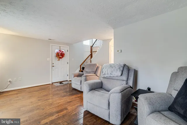 a living room with furniture and stairs