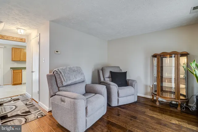 a living room with furniture and large windows