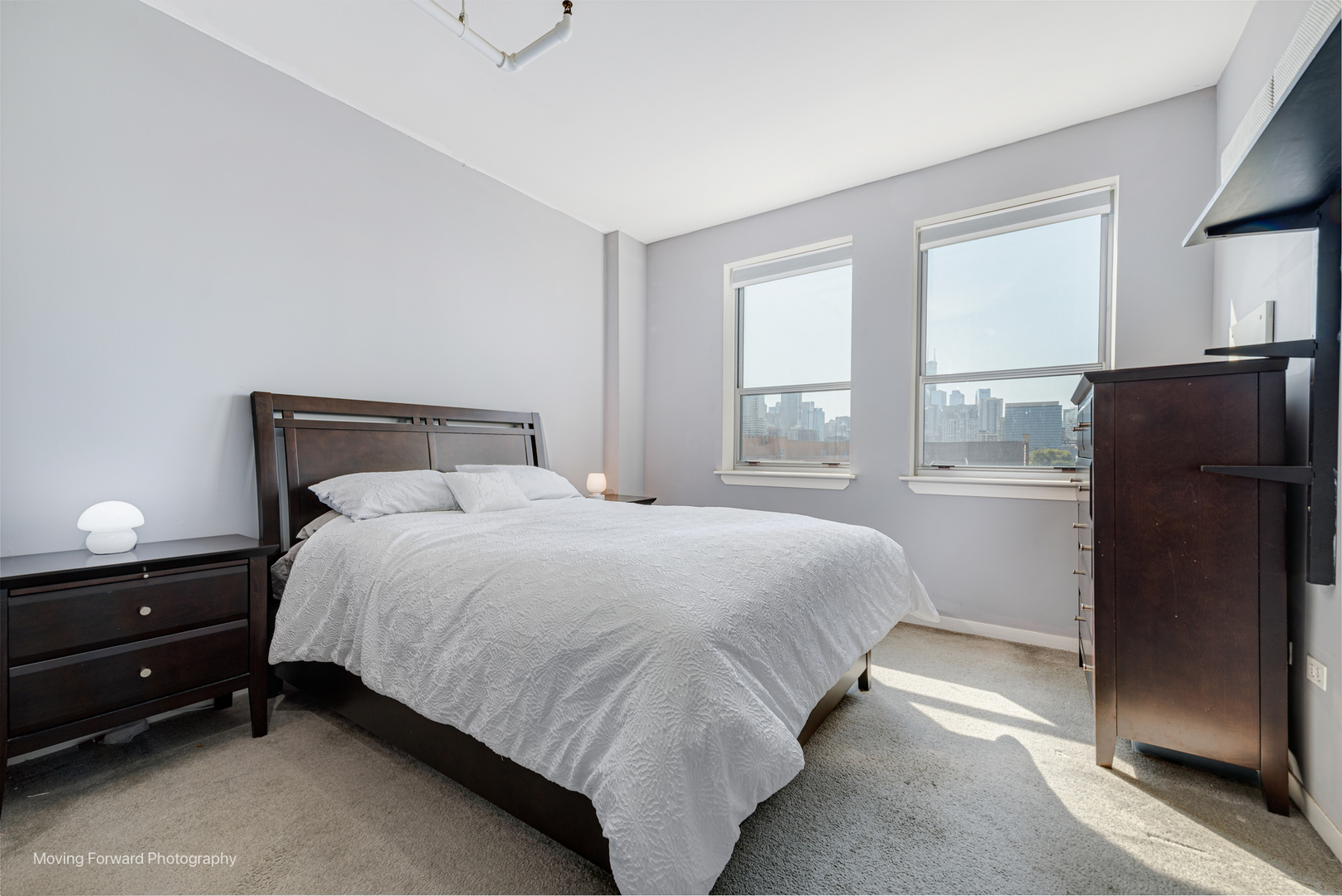 511 West Division Street, Unit 609 Chicago, IL 60610 - Photo 13 of 21 a bedroom with a bed and a refrigerator