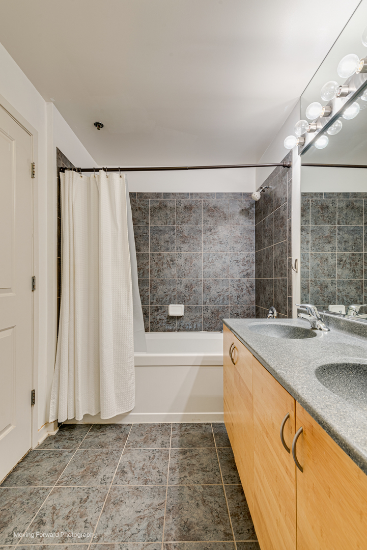 511 West Division Street, Unit 609 Chicago, IL 60610 - Photo 17 of 21 a bathroom with a sink and a bathtub