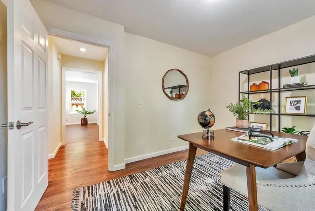 a view of a workspace room with wooden floor