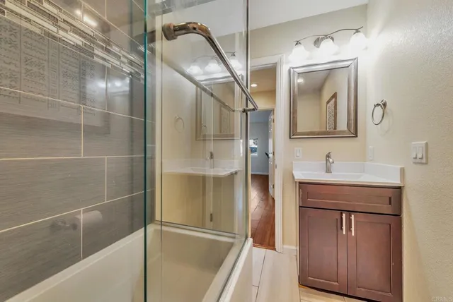 a bathroom with a shower a sink and a mirror