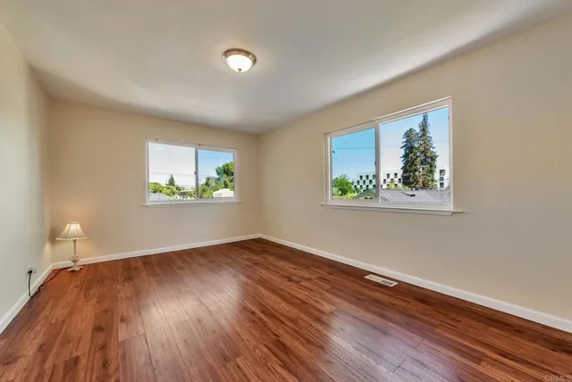 a view of room with window and wooden floor