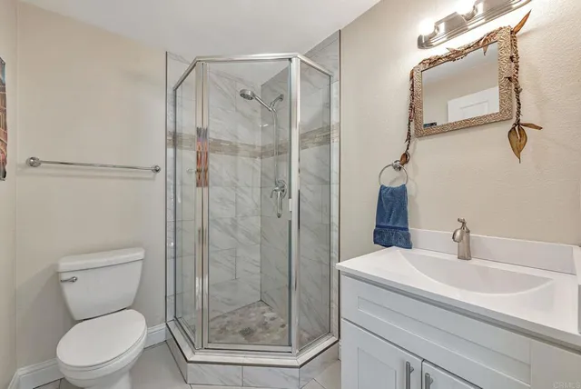 a bathroom with a shower a toilet and a sink