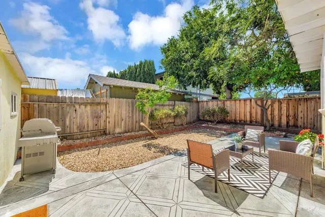 a view of a chairs and tables in the back yard of the house
