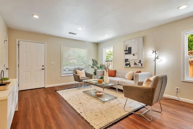 a living room with furniture and wooden floor