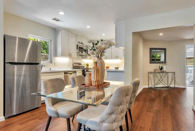a view of a dining room with furniture and wooden floor