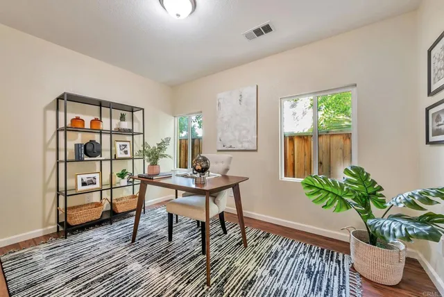 a workspace with furniture window and wooden floor