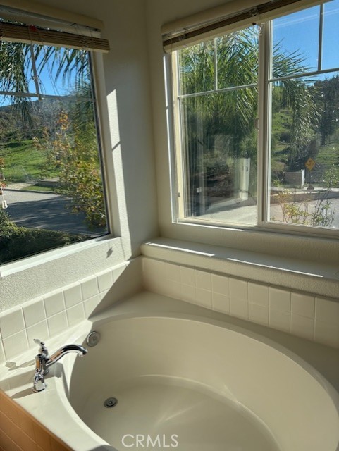 5824 Oak Fern Court Simi Valley, CA 93063 - Photo 15 of 31 a bathroom with a bathtub and a window