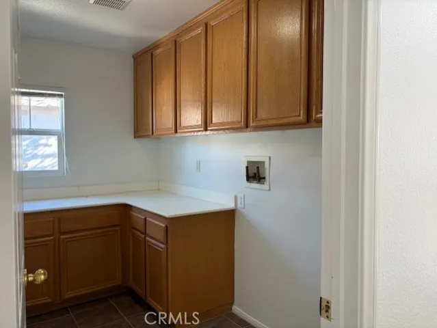 a view of a small space with wooden floor and a window