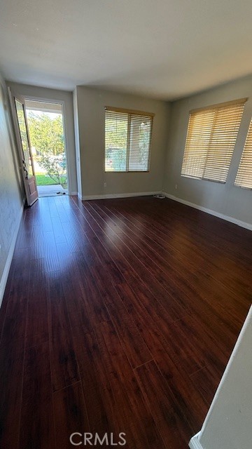 5824 Oak Fern Court Simi Valley, CA 93063 - Photo 4 of 31 a view of an empty room with wooden floor and a window