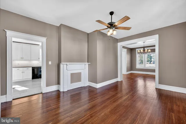 a view of a big room with wooden floor and a ceiling fan