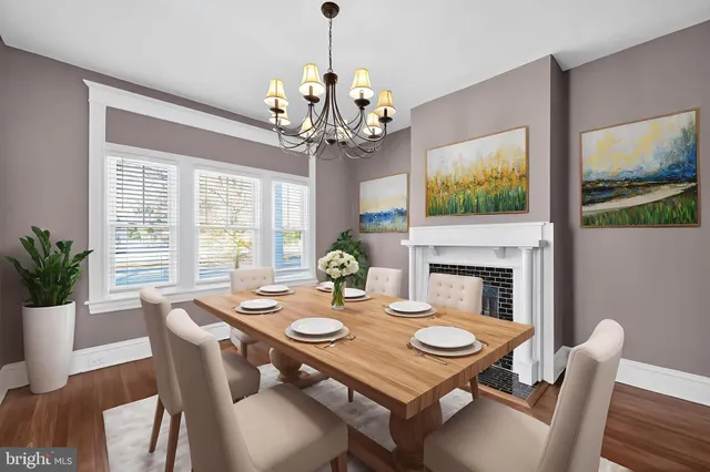 a view of a dining room with furniture a chandelier and wooden floor