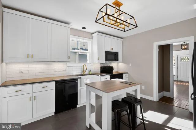a kitchen with cabinets appliances and a counter space