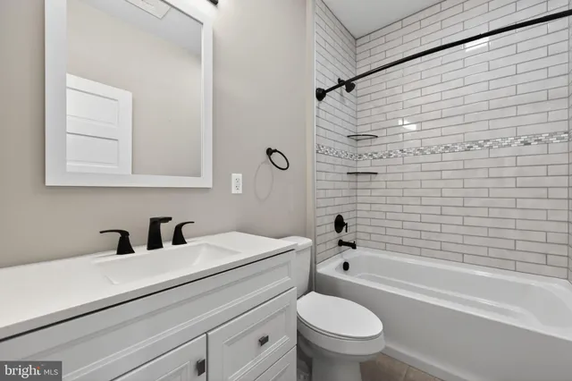 a bathroom with a sink a toilet and a bathtub