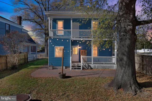 a view of a house with a yard and tree s